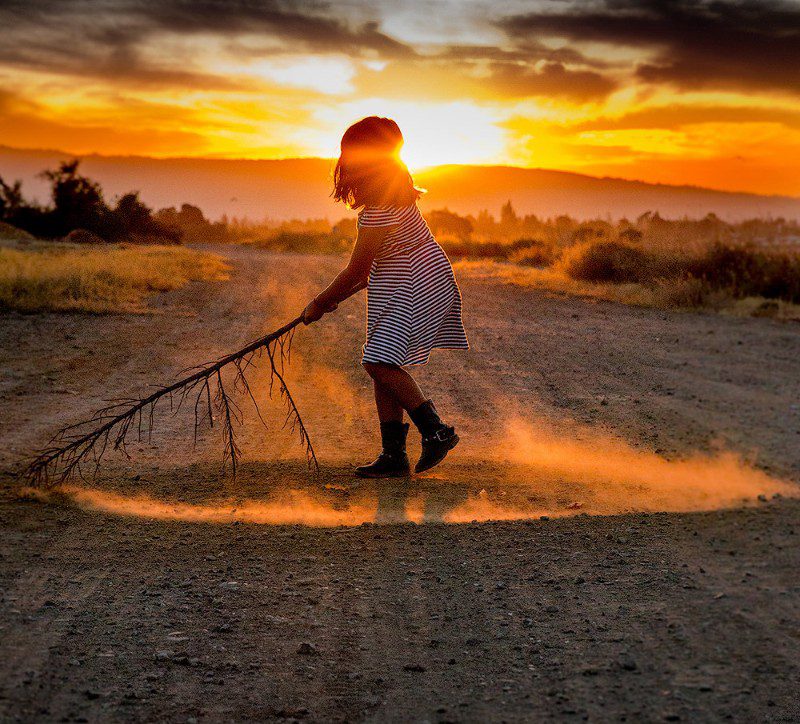 fine_art_photography_sunset_colors_with_young_girl_playing_with_playgound