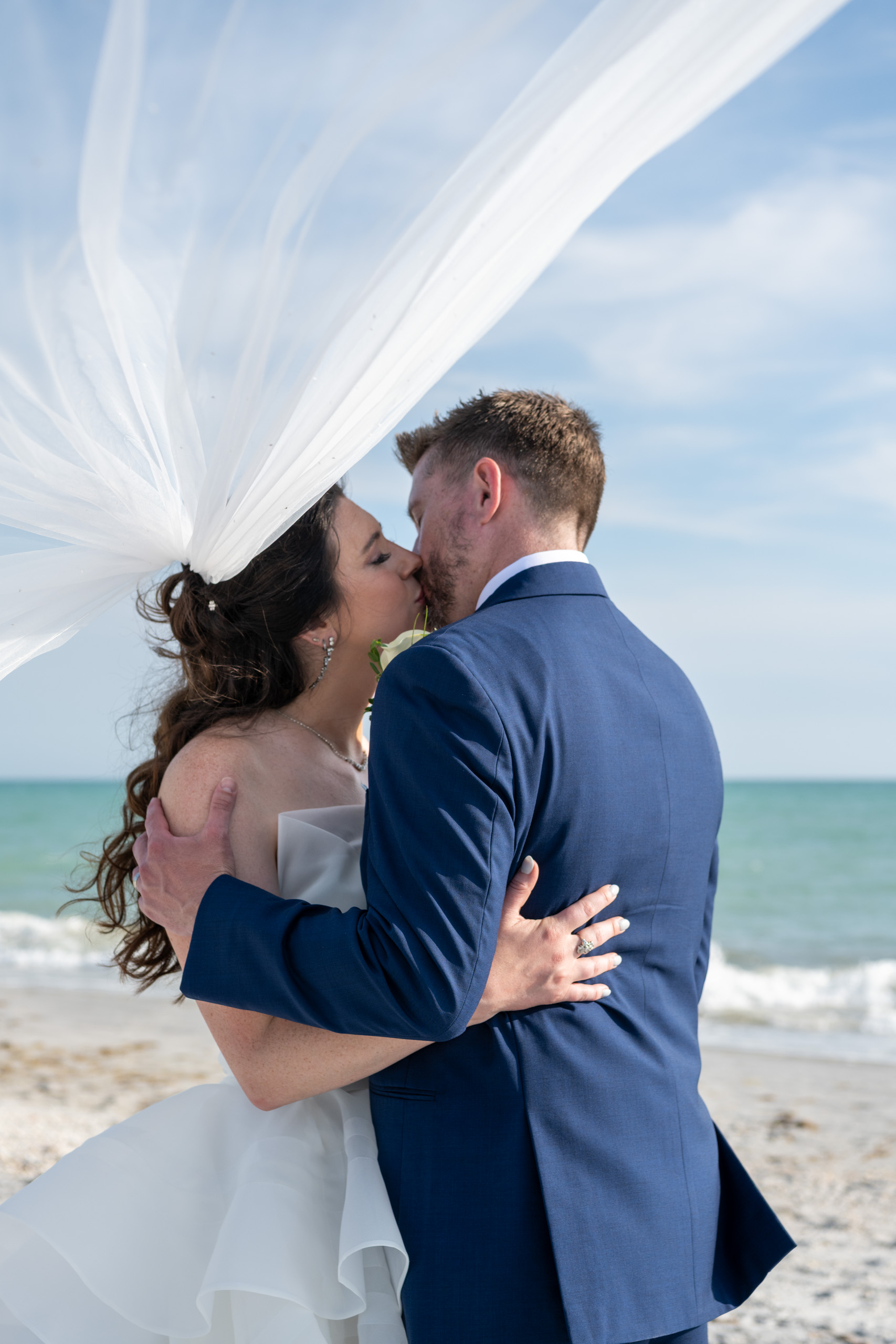 bride groom kissing under her veil